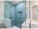 Bathroom featuring a glass shower with blue accent tile and a built-in shelf at 3581 Ridge Se Rd, Smyrna, GA 30080