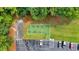 Aerial view of an outdoor exercise area with parking, trees, and manicured lawn at 3957 Marquette Nw Way, Kennesaw, GA 30144