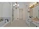 Modern bathroom features a glass shower, a luxurious bathtub, and double vanity with elegant lighting at 3957 Marquette Nw Way, Kennesaw, GA 30144