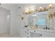 Bright bathroom featuring double vanity with marble countertop and decorative light fixtures at 3957 Marquette Nw Way, Kennesaw, GA 30144