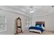 Inviting bedroom with a tray ceiling, ceiling fan, and a full length mirror adjacent to a beautifully made bed at 3957 Marquette Nw Way, Kennesaw, GA 30144