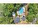 Aerial view of a community pool, playground, and clubhouse nestled among trees and landscaping at 3957 Marquette Nw Way, Kennesaw, GA 30144