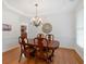 Elegant dining room with a classic chandelier, hardwood floors, and decorative wall accents at 3957 Marquette Nw Way, Kennesaw, GA 30144