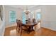 Charming dining room with wainscoting, hardwood floors, and a chandelier, perfect for gatherings at 3957 Marquette Nw Way, Kennesaw, GA 30144