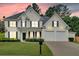 Charming two-story home featuring a well-manicured lawn, two-car garage, and classic black shutters at 3957 Marquette Nw Way, Kennesaw, GA 30144
