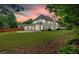 Exterior of the house from the backyard with a colorful sunset at 3957 Marquette Nw Way, Kennesaw, GA 30144