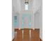 Bright foyer featuring hardwood floors, high ceilings, and views of the front door and windows at 3957 Marquette Nw Way, Kennesaw, GA 30144