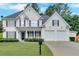Beautiful two-story home with a manicured lawn, black shutters, and a welcoming front porch at 3957 Marquette Nw Way, Kennesaw, GA 30144