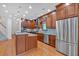 Bright kitchen boasts stainless steel appliances, wood cabinets, island and modern lighting at 3957 Marquette Nw Way, Kennesaw, GA 30144