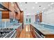 Spacious kitchen featuring a gas range, stainless steel appliances, wood cabinets and granite countertops at 3957 Marquette Nw Way, Kennesaw, GA 30144