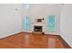 Bright living room featuring hardwood floors, a stone fireplace and large windows at 3957 Marquette Nw Way, Kennesaw, GA 30144