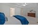 Bright bedroom featuring a bed with blue accents, a dark dresser, and a plant next to large windows at 3957 Marquette Nw Way, Kennesaw, GA 30144