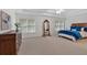 Spacious bedroom showcasing a dark wood dresser and mirror accenting a blue bed set near three large windows at 3957 Marquette Nw Way, Kennesaw, GA 30144