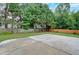 Concrete patio area with large, grassy backyard surrounded by trees at 3957 Marquette Nw Way, Kennesaw, GA 30144