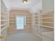 Large walk-in closet with ample shelving, window and neutral carpet at 3957 Marquette Nw Way, Kennesaw, GA 30144