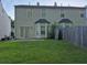 Backyard view showing a fenced-in yard with grass, a patio, and the rear of the home at 5570 Hampton Ct, Atlanta, GA 30349