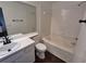 Full white bathroom featuring a tub, a shower, and a single sink vanity at 5570 Hampton Ct, Atlanta, GA 30349