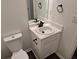 Bathroom featuring a white vanity with black fixtures, a mirror, and a toilet at 5570 Hampton Ct, Atlanta, GA 30349