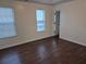 Spacious bedroom featuring a large window and dark wood floors at 5570 Hampton Ct, Atlanta, GA 30349