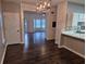 Dining room with breakfast bar featuring hardwood floors and modern light fixture at 5570 Hampton Ct, Atlanta, GA 30349