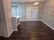 Bright dining room features hardwood floors, modern chandelier, and door to the backyard at 5570 Hampton Ct, Atlanta, GA 30349