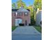 Charming two-story brick home with a well maintained front lawn and driveway on a sunny day at 5570 Hampton Ct, Atlanta, GA 30349