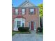 Charming two-story brick home with bay window, red shutters and a well maintained front yard at 5570 Hampton Ct, Atlanta, GA 30349