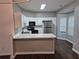 Bright kitchen with white cabinetry, modern appliances, and a breakfast bar overlooking the dining area at 5570 Hampton Ct, Atlanta, GA 30349