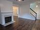 Cozy living room with hardwood floors, fireplace, and open to the staircase at 5570 Hampton Ct, Atlanta, GA 30349