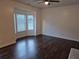 Spacious living room with hardwood floors, large windows, and ceiling fan at 5570 Hampton Ct, Atlanta, GA 30349
