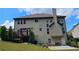 Two story home with a backyard featuring a deck, patio, and manicured greenery at 2819 Heritage Oaks Cir, Dacula, GA 30019