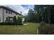 Landscaped backyard featuring a spacious lawn, patio area, and mature trees at 2819 Heritage Oaks Cir, Dacula, GA 30019