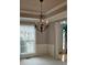 Dining room featuring crown moulding, wainscoting, chandelier, and large windows at 2819 Heritage Oaks Cir, Dacula, GA 30019