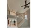 Open living room with stairs, high ceiling, large fan, and lots of natural light at 2819 Heritage Oaks Cir, Dacula, GA 30019
