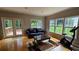 Living room featuring hardwood floors, a couch, large windows, and access to a back deck at 2819 Heritage Oaks Cir, Dacula, GA 30019