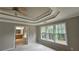 Main bedroom with tray ceiling, large windows, and en-suite bathroom at 2819 Heritage Oaks Cir, Dacula, GA 30019