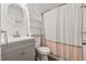Updated bathroom with a vanity, shower with curtain, and white shelving at 3123 Deshong Dr, Stone Mountain, GA 30087