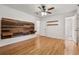 Spacious primary bedroom with hardwood floors, wooden wall decor, and ensuite bathroom at 3123 Deshong Dr, Stone Mountain, GA 30087