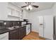 Functional kitchen with white appliances, wood floors, and updated countertops at 3123 Deshong Dr, Stone Mountain, GA 30087