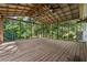 Expansive screened-in porch with wooden floor and ample light for enjoying the surrounding nature at 3123 Deshong Dr, Stone Mountain, GA 30087