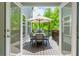 Outdoor deck area featuring a table set, grill and tranquil view of the surrounding greenery at 3755 Valleyway Rd, Cumming, GA 30040