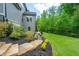 Lush backyard featuring stone steps, a manicured lawn, and mature trees at 3755 Valleyway Rd, Cumming, GA 30040