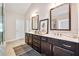 Bathroom with dual sinks, dark wood cabinetry, and large mirrors at 3755 Valleyway Rd, Cumming, GA 30040