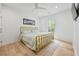 Bright bedroom featuring hardwood floors, a modern gold bed frame, and a large window at 3755 Valleyway Rd, Cumming, GA 30040