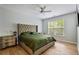 Stylish bedroom featuring hardwood floors, tufted headboard, and modern decor at 3755 Valleyway Rd, Cumming, GA 30040