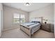 Comfortable bedroom with a wood-trimmed bed, plush carpet, and a window view at 3755 Valleyway Rd, Cumming, GA 30040