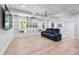 Large bonus room with hardwood floors, custom built-ins, and a wall-mounted TV at 3755 Valleyway Rd, Cumming, GA 30040