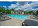 Large community pool featuring plenty of lounge chairs, tables, and umbrellas to enjoy during the warm summer months at 3755 Valleyway Rd, Cumming, GA 30040