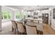 Open concept dining area with an eat-in kitchen, large windows, and hardwood flooring at 3755 Valleyway Rd, Cumming, GA 30040