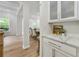 Hallway featuring white cabinets, quartz countertops, and access to dining area and sitting room at 3755 Valleyway Rd, Cumming, GA 30040
